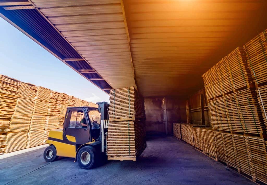 forklift loader loads lumber into a dry kiln for wood drying