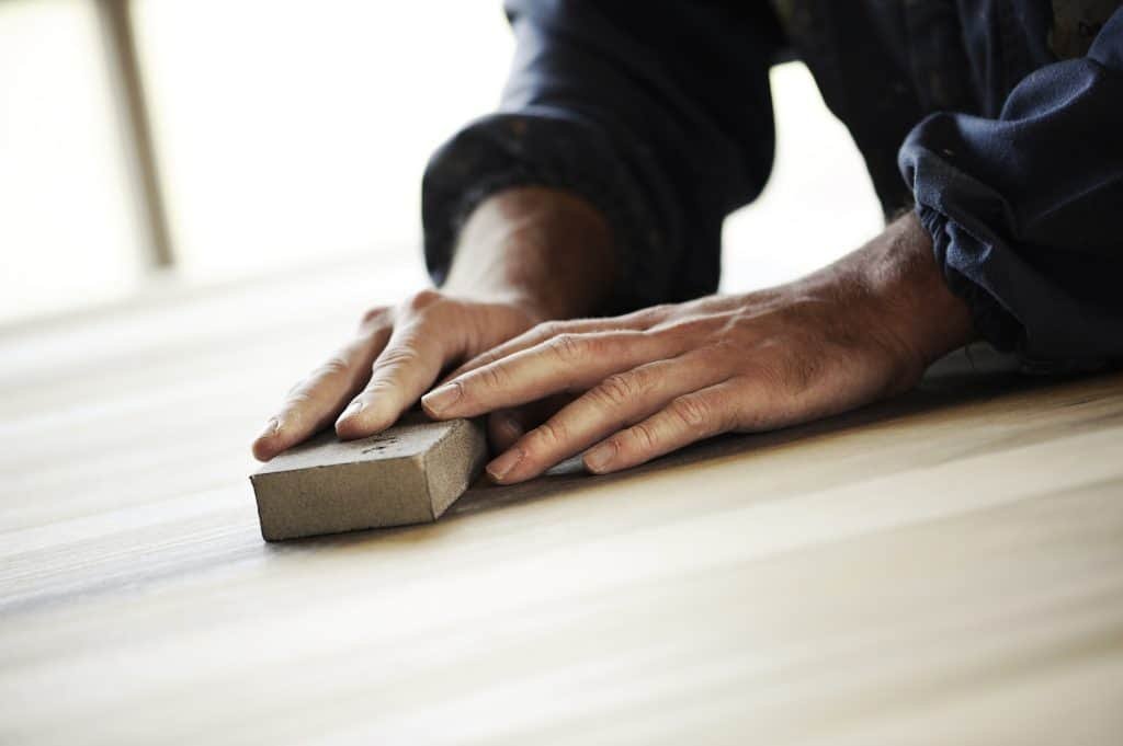 a man using a sanding block