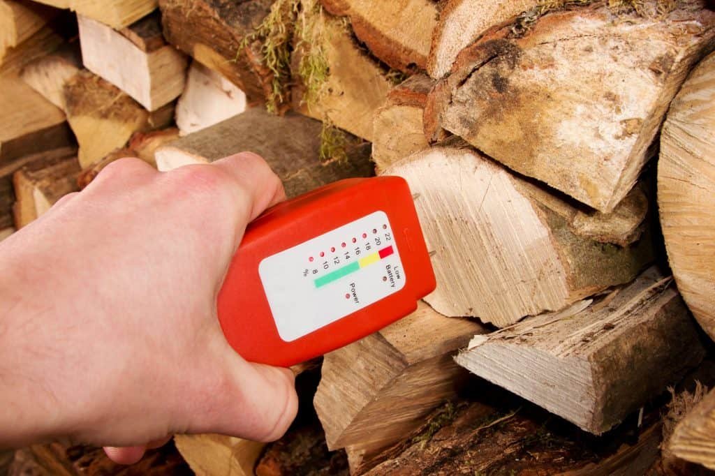 using a moisture meter to check how dry the wood is