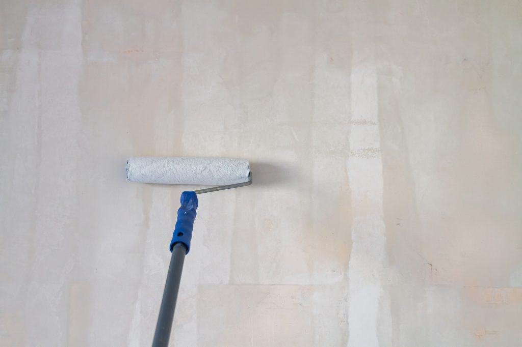 applying primer on drywall before tiling