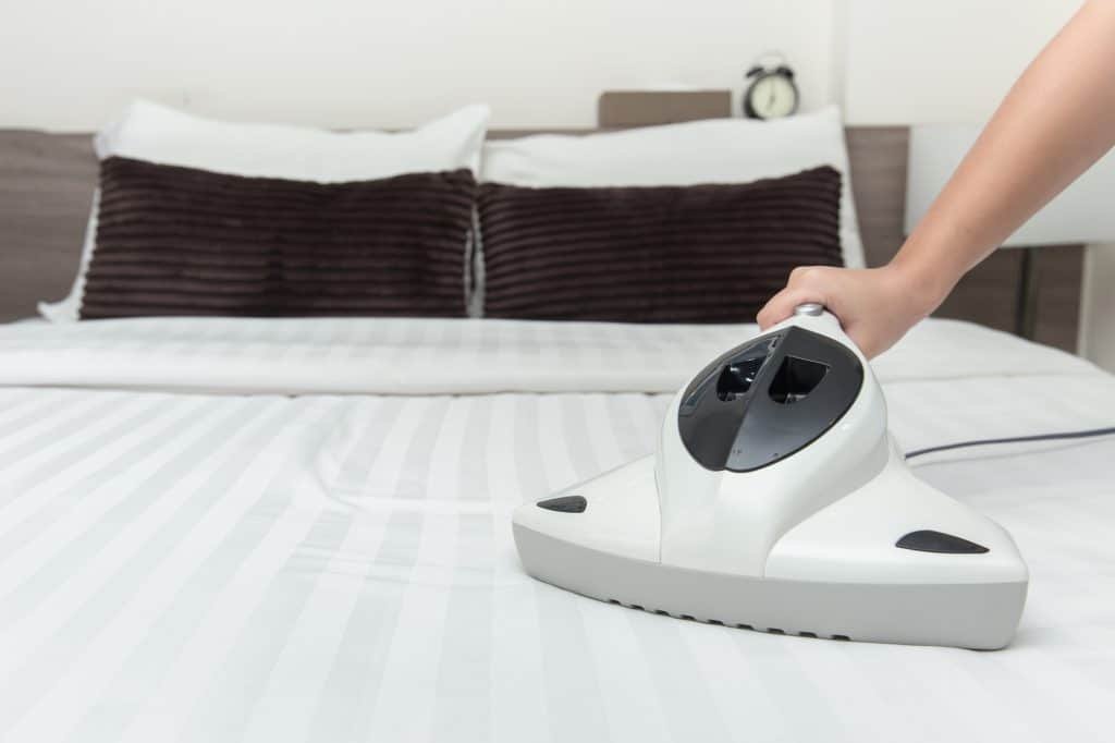 cleaning bed thoroughly by a vacuum cleaner