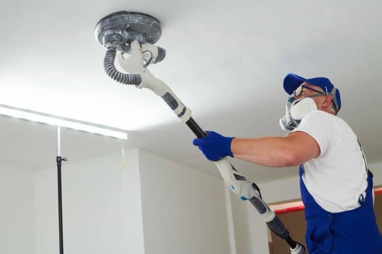 man sanding drywall