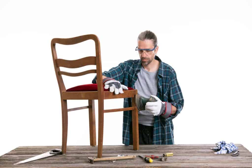 sanding a chair with a mouse sander