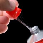 person opening a glue tube