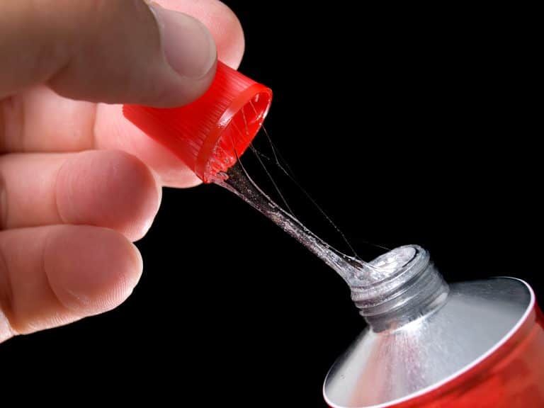 person opening a glue tube