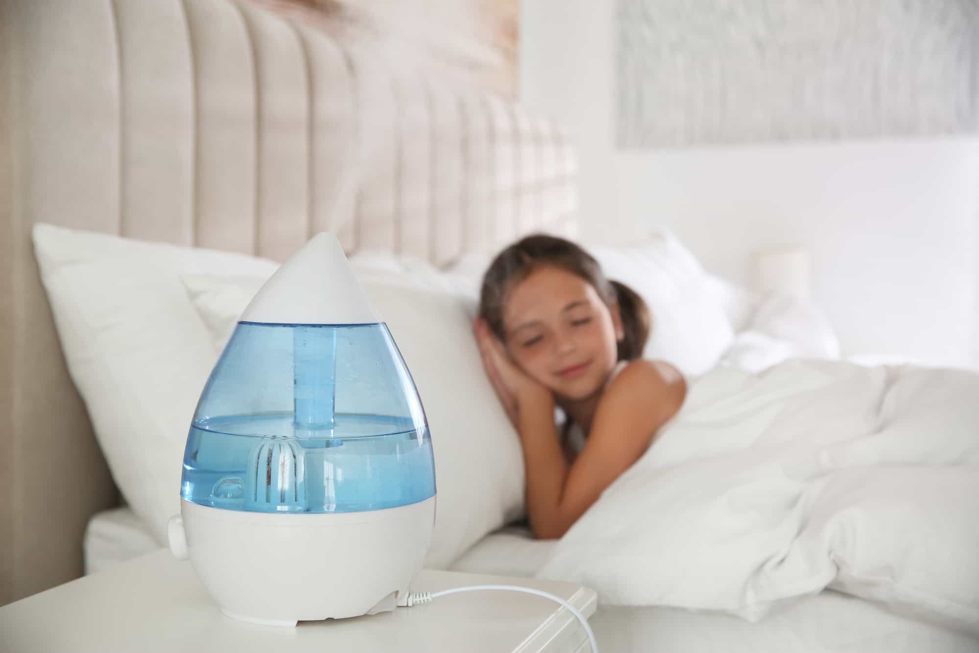 little girl sleeping in the bedroom with air humidifier