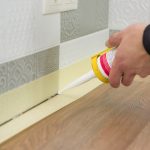 applying caulk in the gap