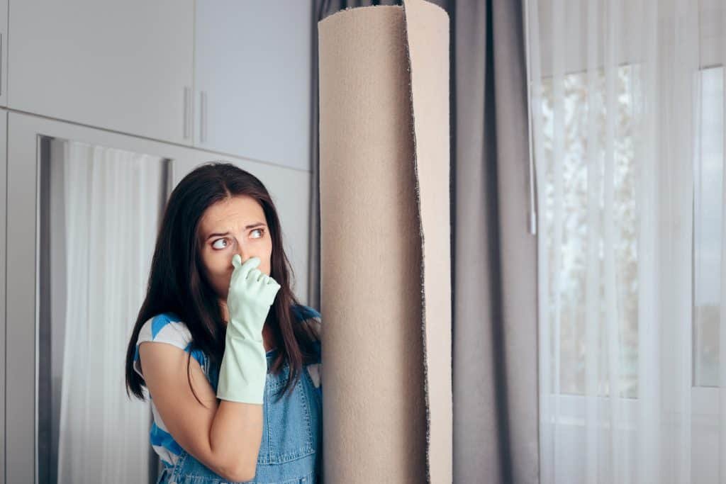 woman covering her nose because of the smell