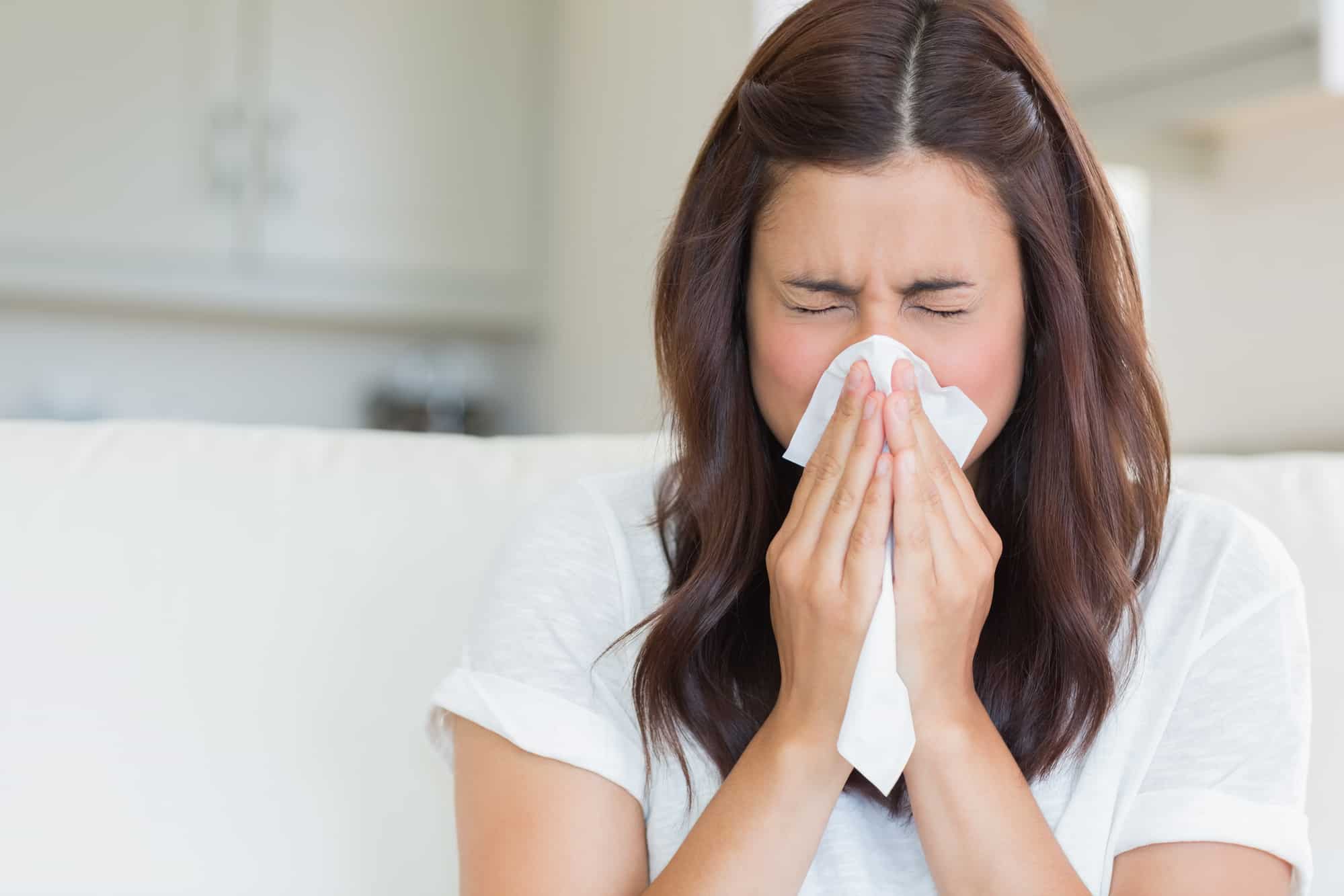 woman is sneezing because of weed-like smell in her house