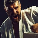 Karate man trying to break a brick with his hand