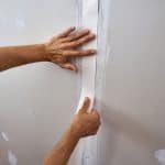 covering drywall seams by a tape