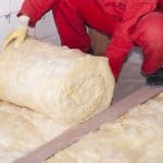 man insulating between floors