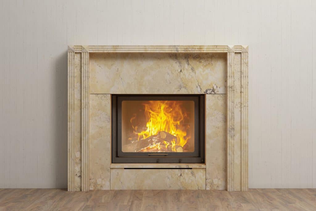 limestone fireplace with fire in home interior