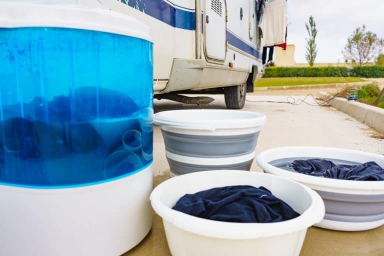 washing machine and bowl of clothes outside the house