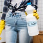 woman holding a gallon of bleach