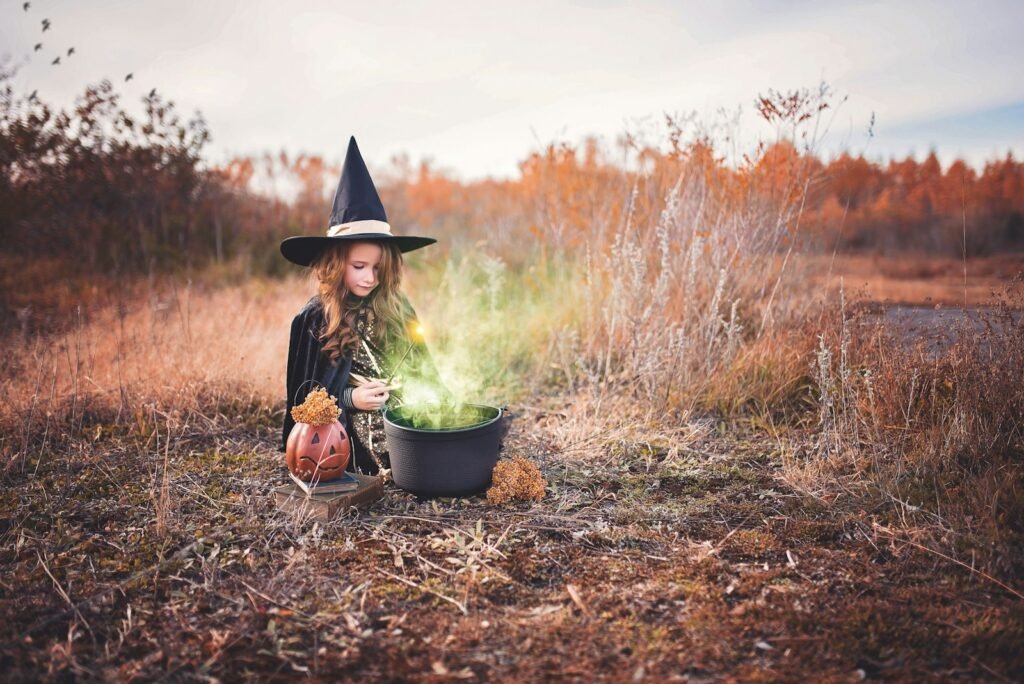 girl in witch costume Halloween decorations