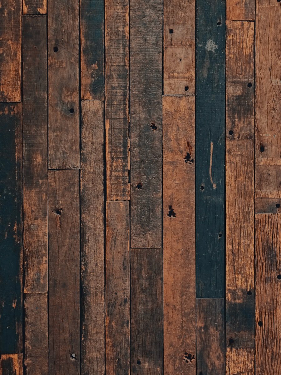 A close up of a wooden floor with a brown background