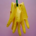 yellow gloves on blue clothes hanger cleaning products