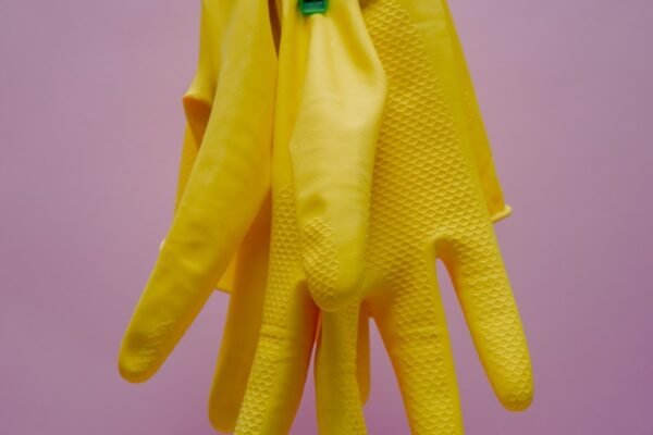 yellow gloves on blue clothes hanger cleaning products